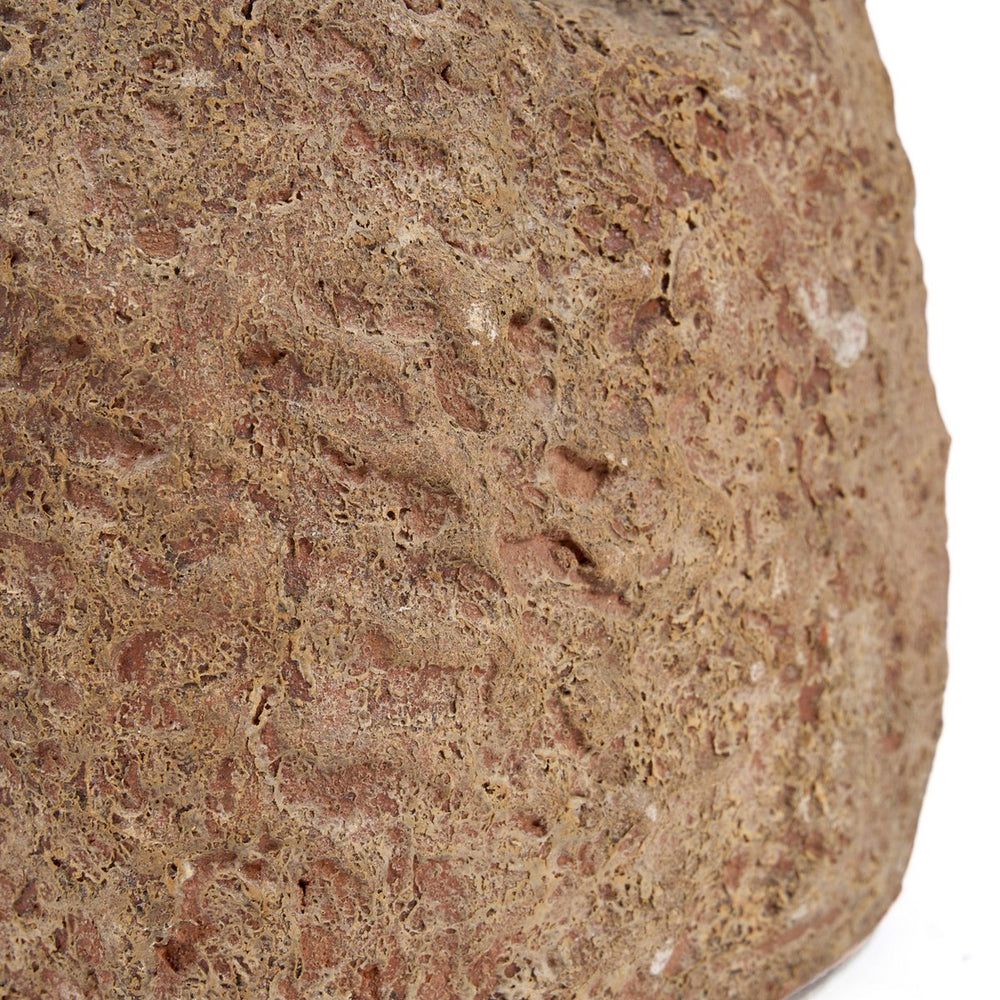 Close-up of a textured brown stone on a white background