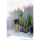 Black terracotta planter on teak branch stand