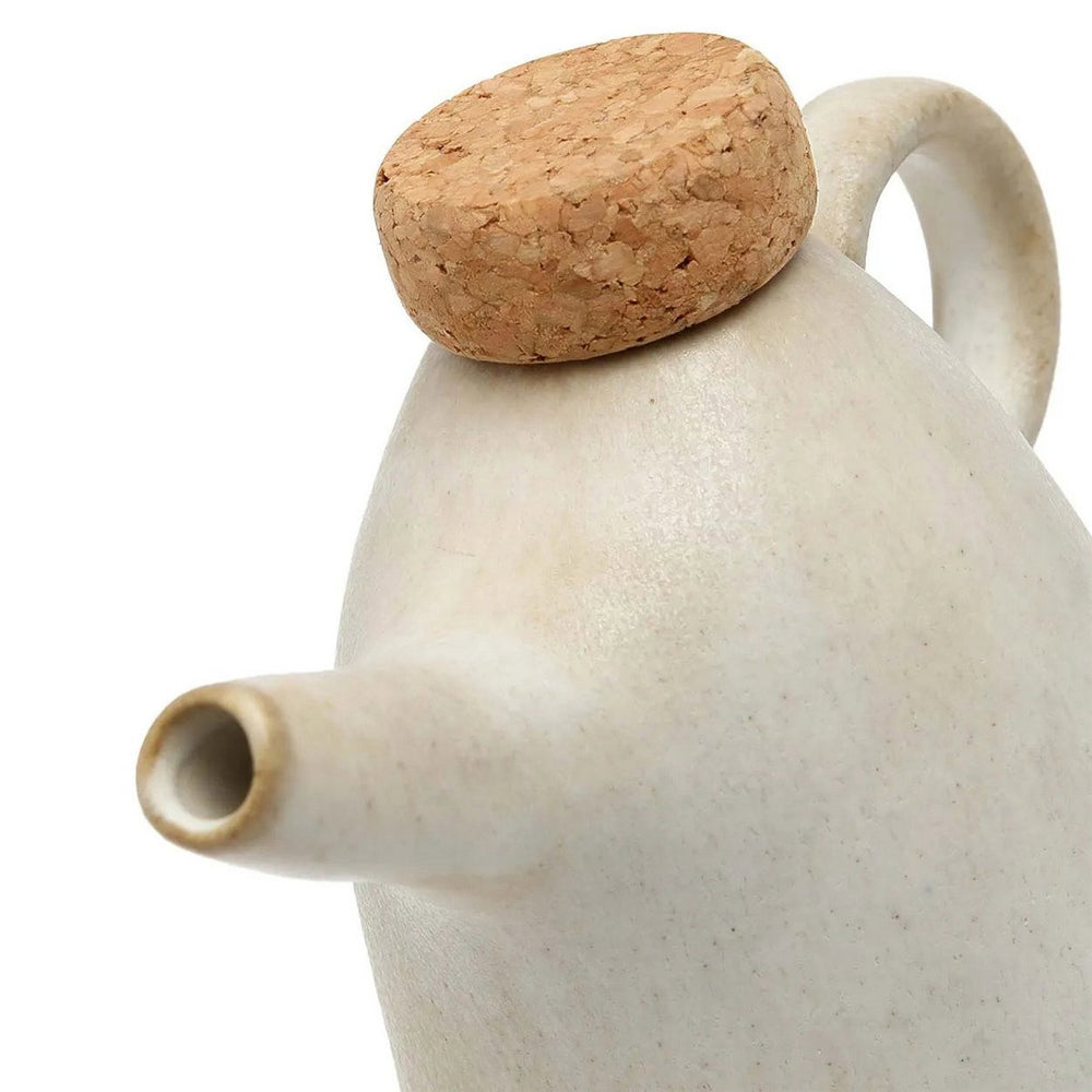 Ceramic teapot with cork lid on a white background