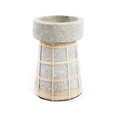 Concrete planter with woven rattan around it on a white background