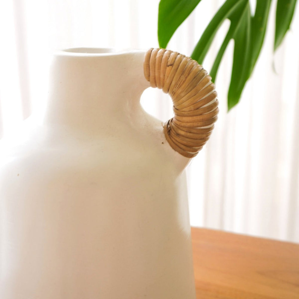 White clay vase with rattan-wrapped handle