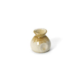 Beige ceramic sauce pourer with white honey glaze