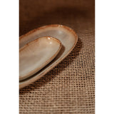 Two ceramic plates on a textured brown surface