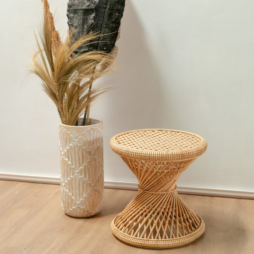 Beige rattan round side table with hourglass-shaped struts