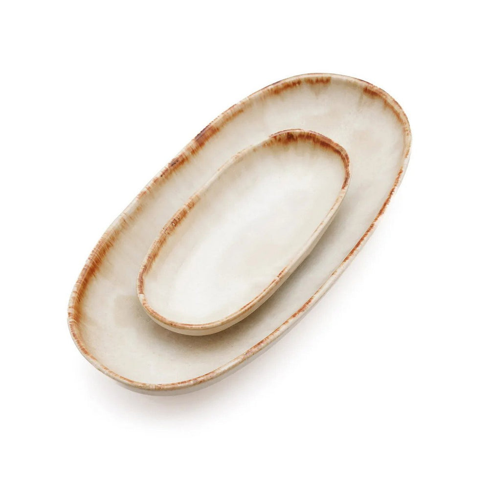 Set of two oval ceramic trays with rustic edges on a white background