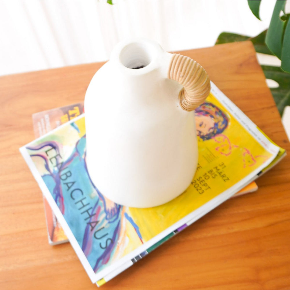 White clay vase with rattan-wrapped handle