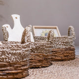 Beige and brown woven seagrass and banana fibre storage basket