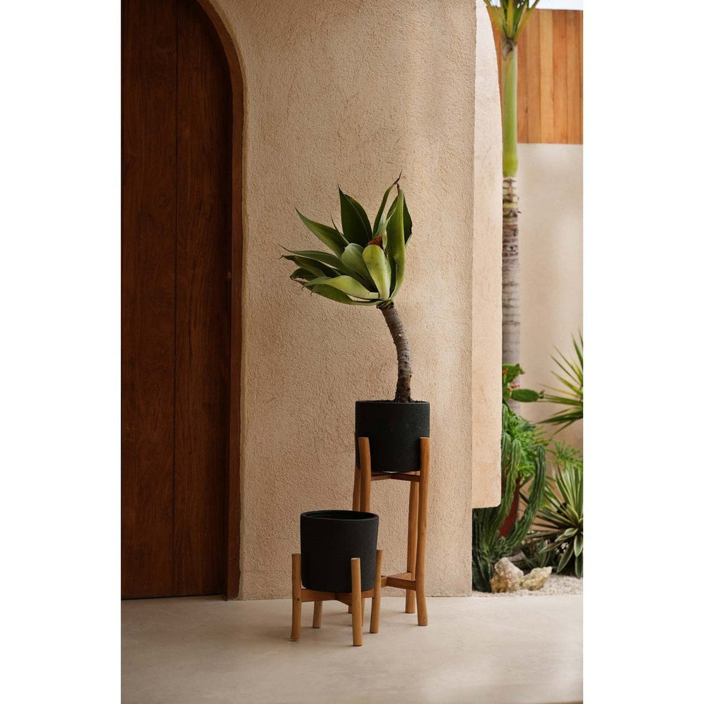 Black terracotta planter on teak branch stand