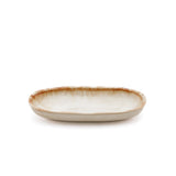 Ceramic dish with brown rim on a white background