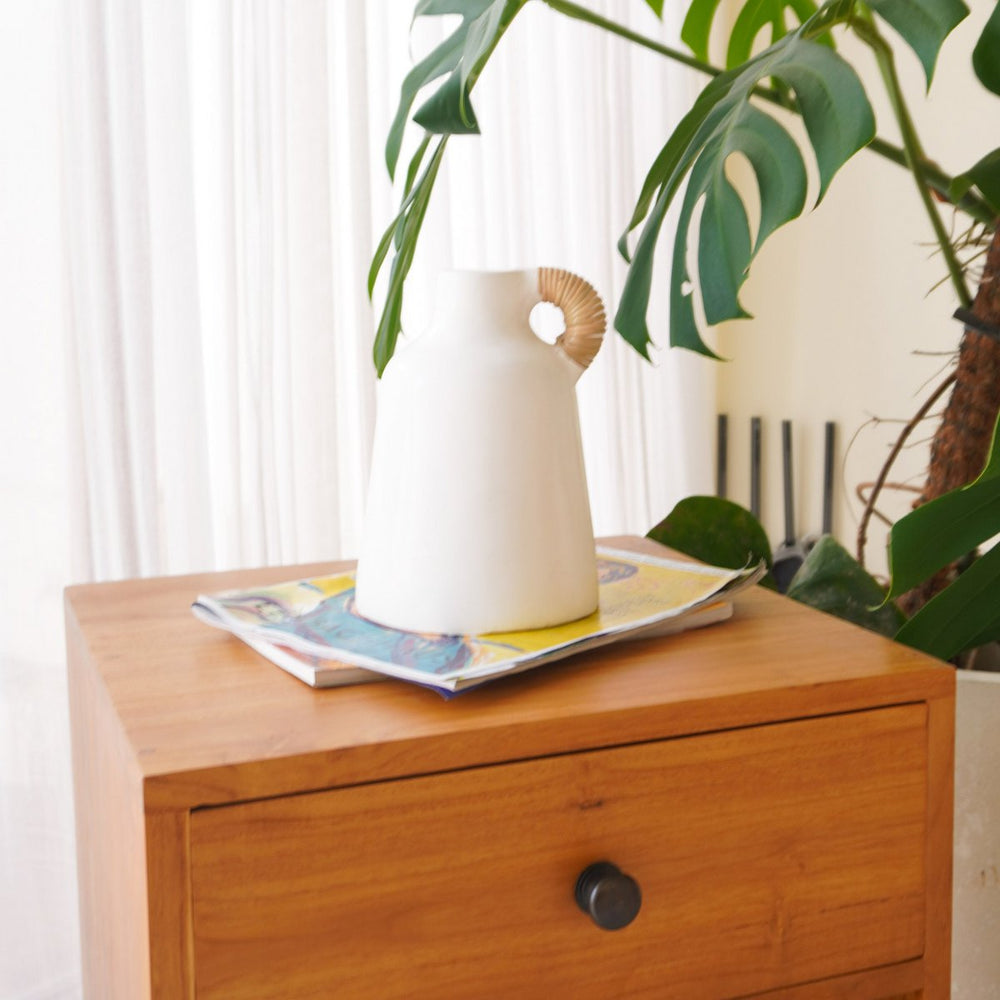 White clay vase with rattan-wrapped handle